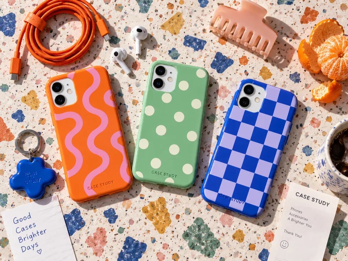 Three patterned phone cases with matching accessories on colourful terrazzo